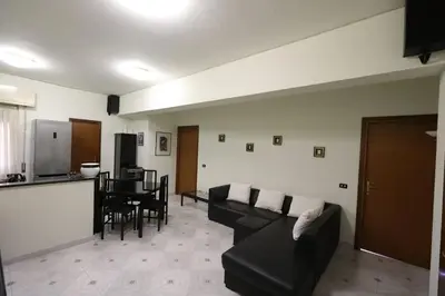 a living room with a couch and a table at Pochi passi da San Pietro Metro A Cipro in Rome