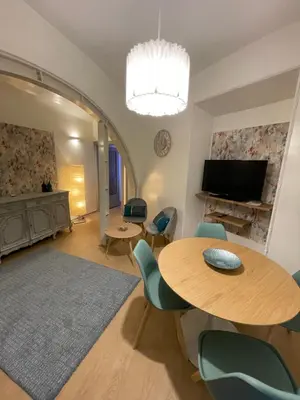 a living room with a table and chairs and a television at Blue vatican house Rome in Rome