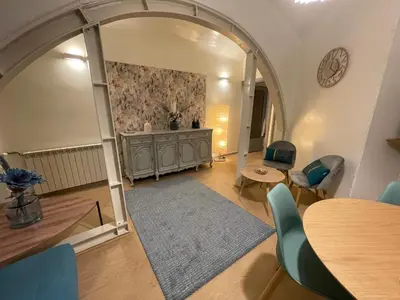 a living room with an archway and a table and chairs at Blue vatican house Rome in Rome
