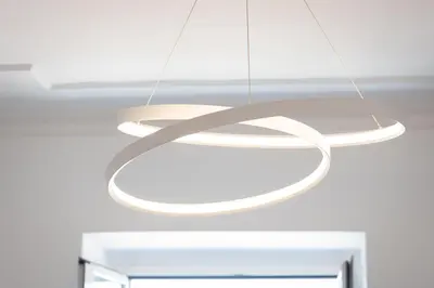 a large white light fixture hanging from a ceiling at Colosseo Modern by Rental in Rome in Rome