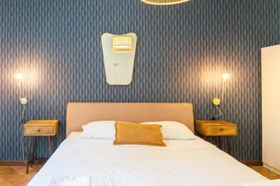a bedroom with a white bed with two night stands at EasyTopStay - Piazza Navona Charming Apartment in Rome