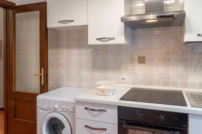 a kitchen with a washing machine and a sink at La Maison D'Amelia in Rome