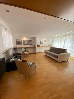 a living room with a couch and a chair at Giulio Cesare Holiday House in Rome