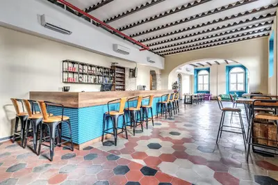 a bar in a room with chairs and tables at Borgo Ripa Urban Travel in Rome
