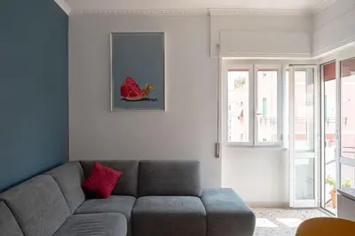 a living room with a gray couch and red pillows at Nel cuore di Monteverde in Rome