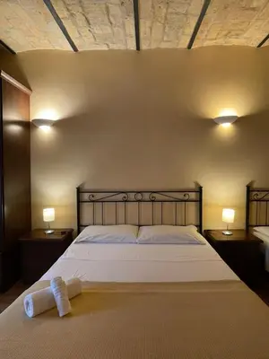 a bedroom with a bed with a towel on it at Holiday Suite Roma in Rome