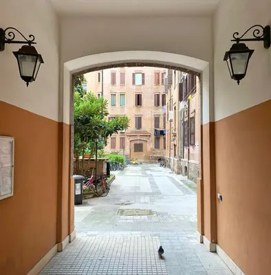 an empty alley with an archway in a city at La Dolce Vita - Old Testaccio Luxury Apartment in Rome