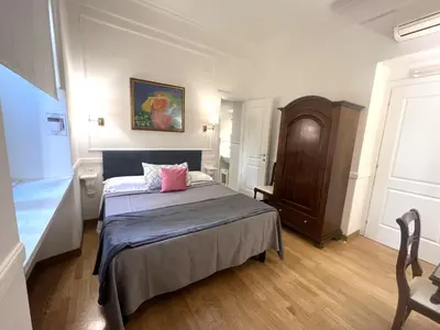 a bedroom with a bed and a painting on the wall at INTERNO ROMA in Rome