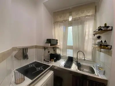 a small kitchen with a sink and a counter top at La casa dell’Appio in Rome