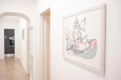 a picture frame on a wall next to a hallway at Vatican Museum Apartment in Rome