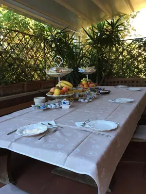 a table with a white table cloth with fruit on it at Trastevere Belvedere B&B in Rome
