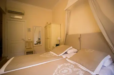 a bedroom with a large bed with a canopy at Trastevere Belvedere B&B in Rome