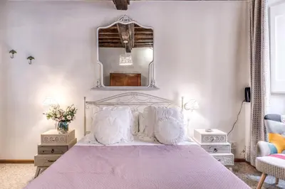 a white kitchen with white cabinets and a sink at Capocci Luxury Home in Rome