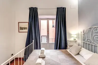a small room with a bed and a window at MyRHome - Spanish Steps in Rome