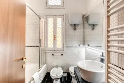 a white bathroom with a sink and a toilet at MyRHome - Spanish Steps in Rome
