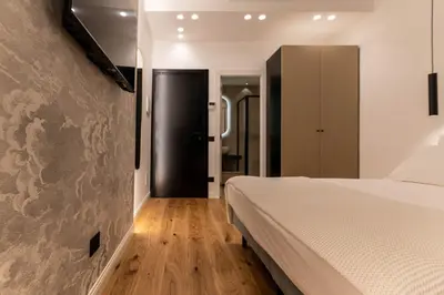 a bedroom with a bed and a wall at Scipioni Luxury Suite in Rome