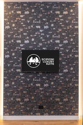 a sign on a wall with a patterned wallpaper at Scipioni Luxury Suite in Rome