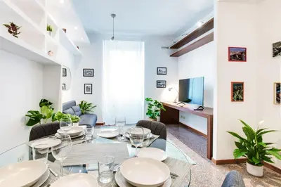a dining room with a glass table and chairs at Antinori Testaccio Cozy Apartment in Rome