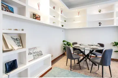a dining room with a table and chairs at Antinori Testaccio Cozy Apartment in Rome