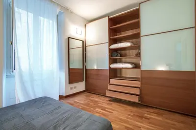 a bedroom with a bed and a dresser and a mirror at Antinori Testaccio Cozy Apartment in Rome