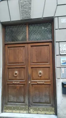 a pair of wooden doors in a building at Germanico Apartments in Rome