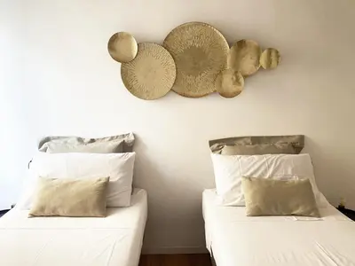 two beds with white sheets and hats on the wall at Germanico Apartments in Rome