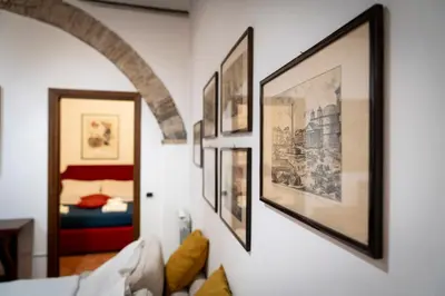 a room with framed pictures on the wall at Casa De' Medici in via Giulia in Rome
