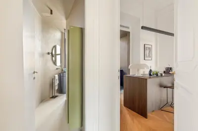 a bathroom with a green door leading into a room at Charm and Elegance by The Spanish Steps in Rome