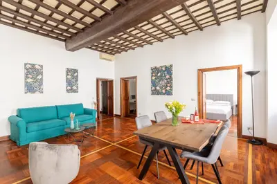 a living room with a table and a couch at Campo de Fiori Large and Beautiful Apartment in Rome