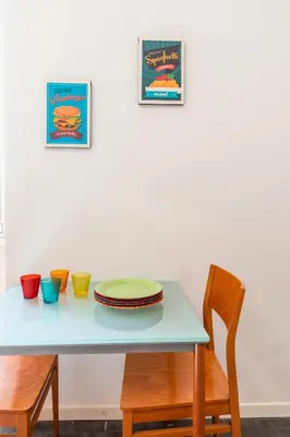 a table with plates and bowls on top of it at Campo de Fiori Large and Beautiful Apartment in Rome