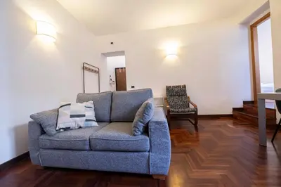 a living room with a couch and a chair at FRAM Apartment Fori Imperiali in Rome