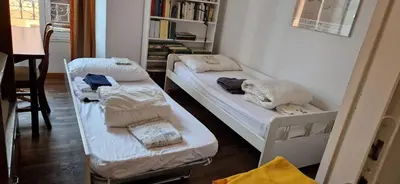 two bunk beds in a room with a book shelf at Large apartment in Rome city center in Rome