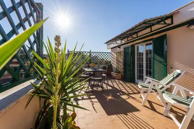 a patio with chairs and a table on a balcony at 4BNB - Loft del Papa in Rome