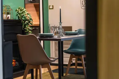 a dining room table with chairs and a candle on it at 4BNB - Loft del Papa in Rome