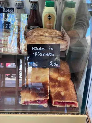 a display case in a bakery with sandwiches and bread at M&M Pigneto Roma in Rome