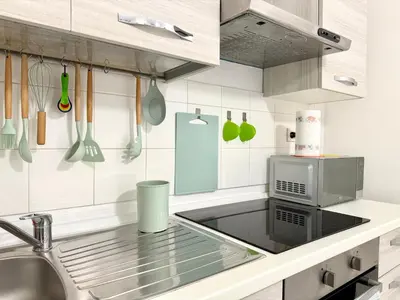 a kitchen with a sink and a microwave at Vaticano - 5 min da stazione in Rome