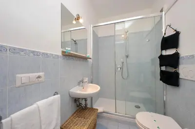 a bathroom with a shower and a sink and a toilet at Cozy Merulana in Rome