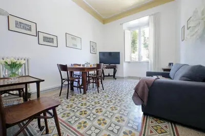 a living room with a couch and a table at Cozy Merulana in Rome