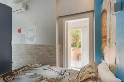a bedroom with a bed and a door to a patio at Excellence Suite in Rome