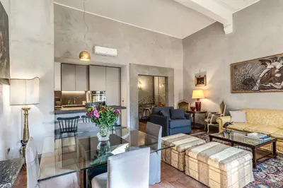 a dining room with a painting on the wall at Stylish 2 BDR Apt with Balcony by Pantheon & Forum in Rome