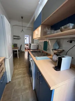 a kitchen with blue cabinets and a sink and a dishwasher at Flaminia@213 in Rome