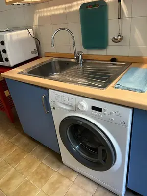 a kitchen with a sink and a washing machine at Flaminia@213 in Rome