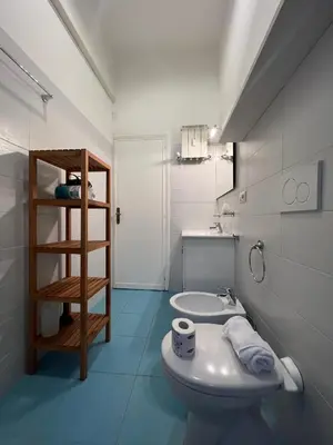 a white bathroom with a toilet and a sink at Flaminia@213 in Rome
