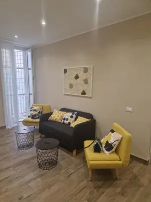 a living room with a couch and two chairs at Cozy Luxury Room Turati in Rome