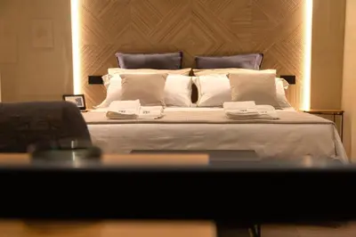 a bedroom with a large bed with white pillows at Loft Bianca Mano in Rome