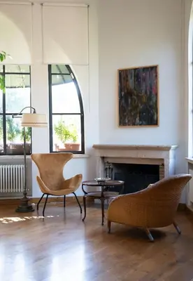 a living room with two chairs and a fireplace at Villa Terme di Caracalla with private Swimming Pool in Rome