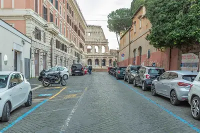 a street with cars parked on the side of the road at Colosseum house in Rome