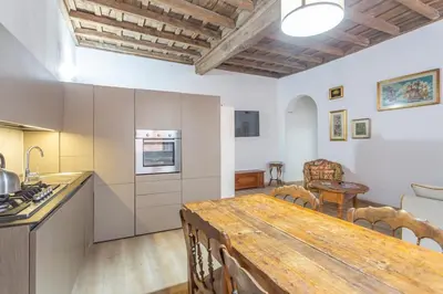 a kitchen and dining room with a wooden table at Colosseum house in Rome