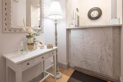 a bathroom with a sink and a mirror and a lamp at Residenza Castrense in Rome