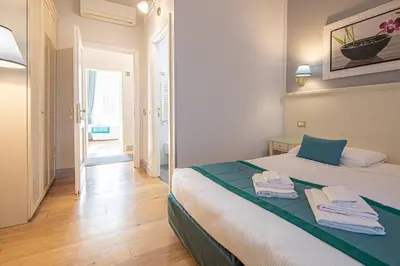 a bedroom with a bed with towels on it at Residenza Castrense in Rome